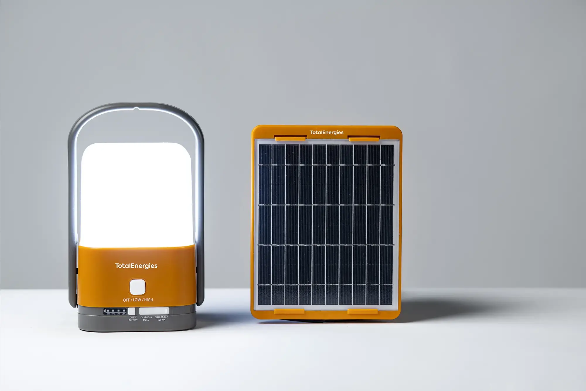 Family Sunshine solar lamp next to solar panel