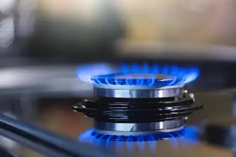 An image of a gas hob heating up a pan in a kitchen.