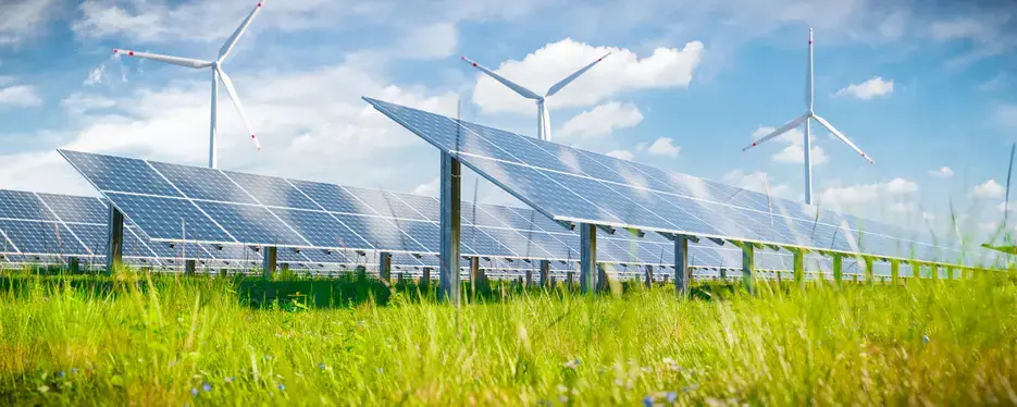 Renewable energy landscape with bright sunshine, solar panels and wind turbines