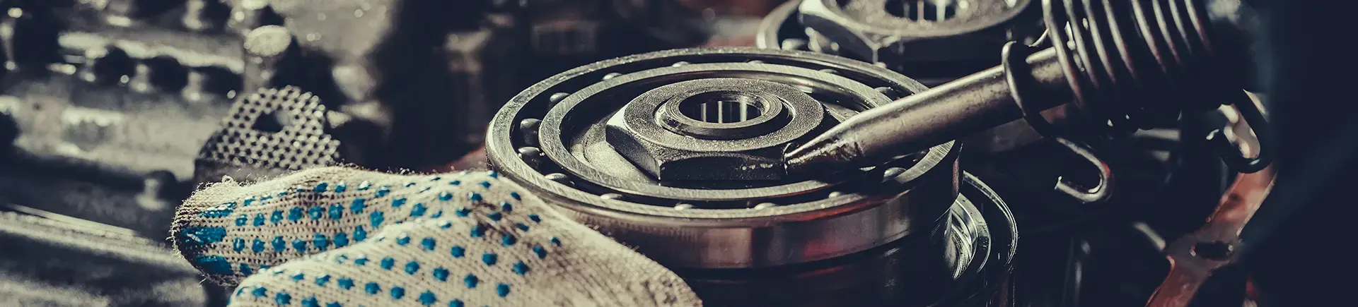 mechanic repairing transmission of a car