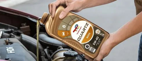 pouring TotalEnergies Quartz 5W-40 engine oil into car