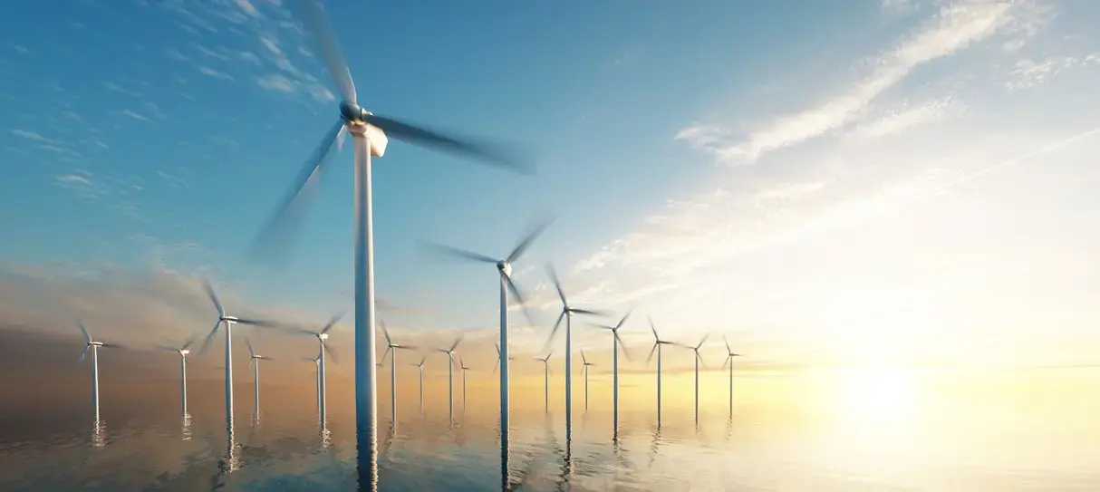 Wind turbines in a calm sea with the horizon in the background