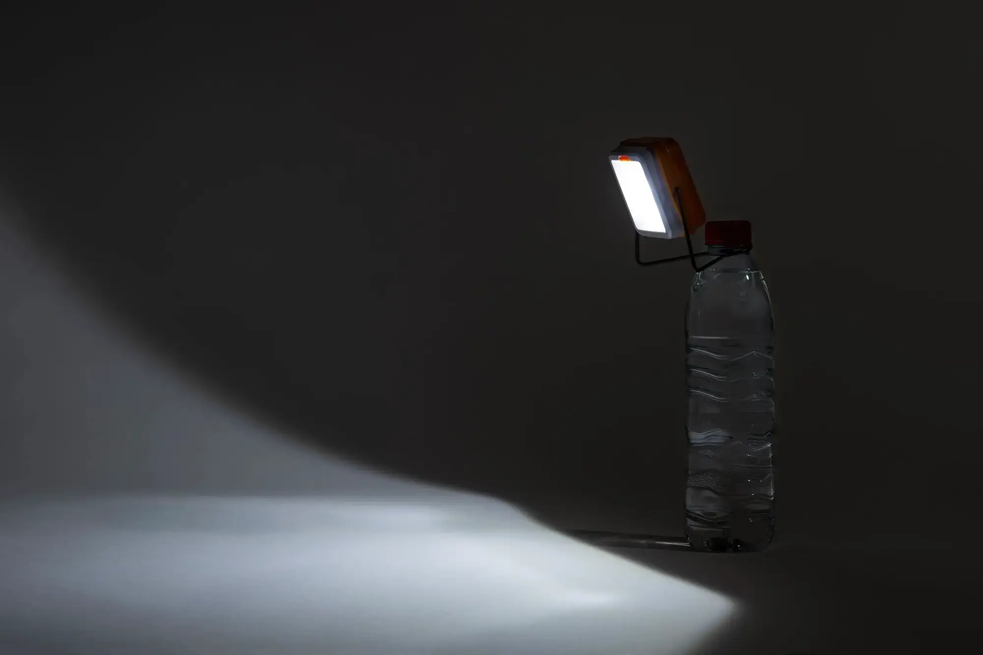 Lit Pocket Sunshine solar lamp hung on a water bottle