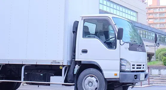 white truck parked near white building during daytime