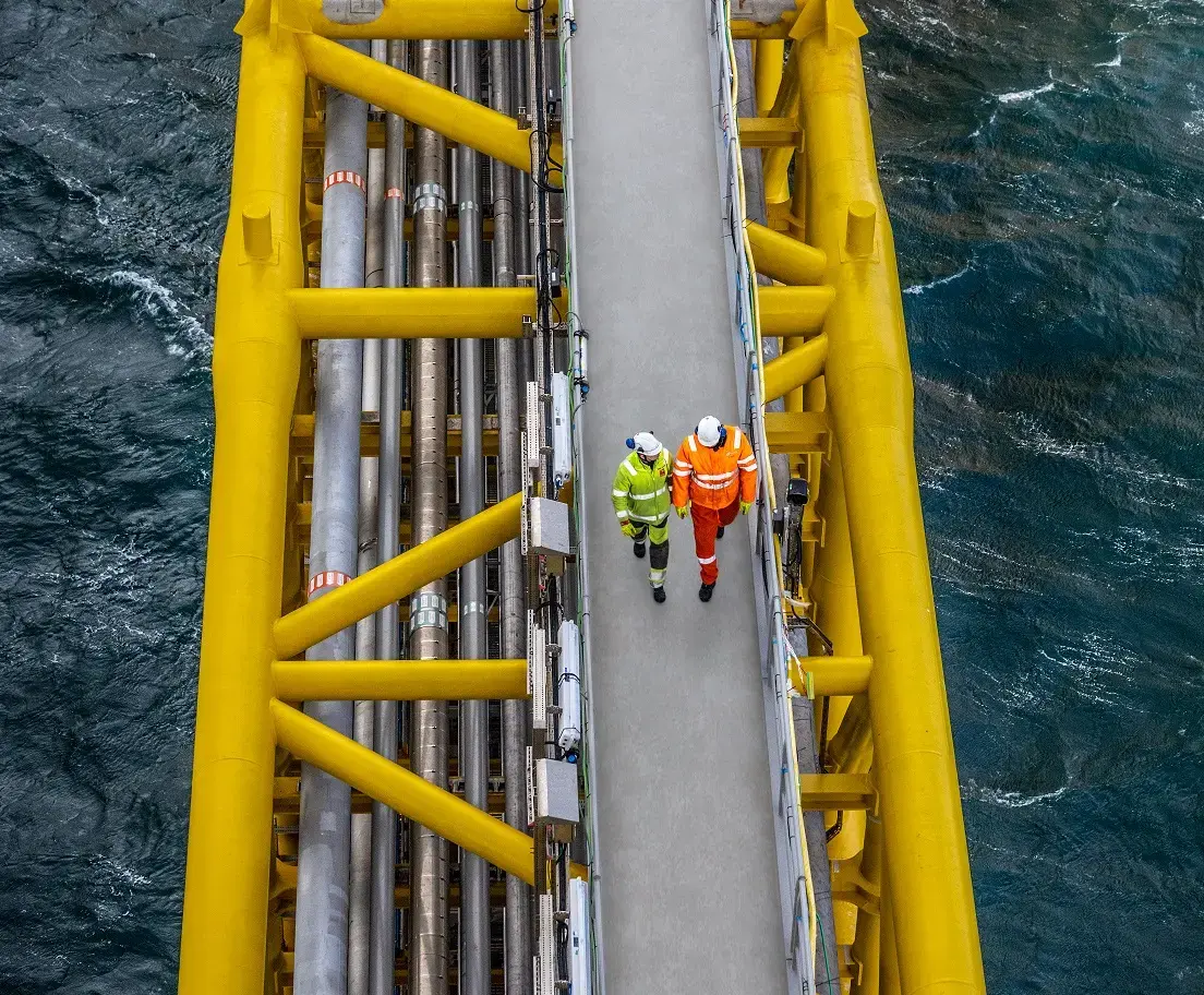 Two people walking on an offshore platform in the Danish North sea 