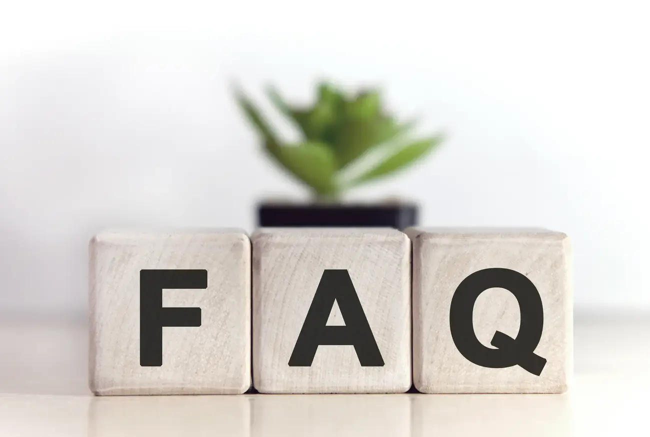 An image of three wooden blocks. Each wooden block has a letter on it, spelling out F.A.Q.