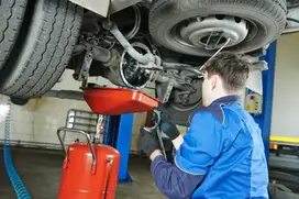 mechanic servicing a car at a workshop