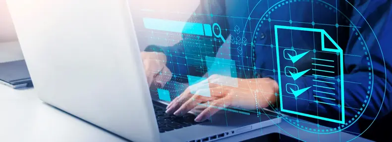 An image of an individual working on a laptop with checklist graphics in the foreground.