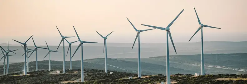An image of a collection of wind turbines on a hill together.