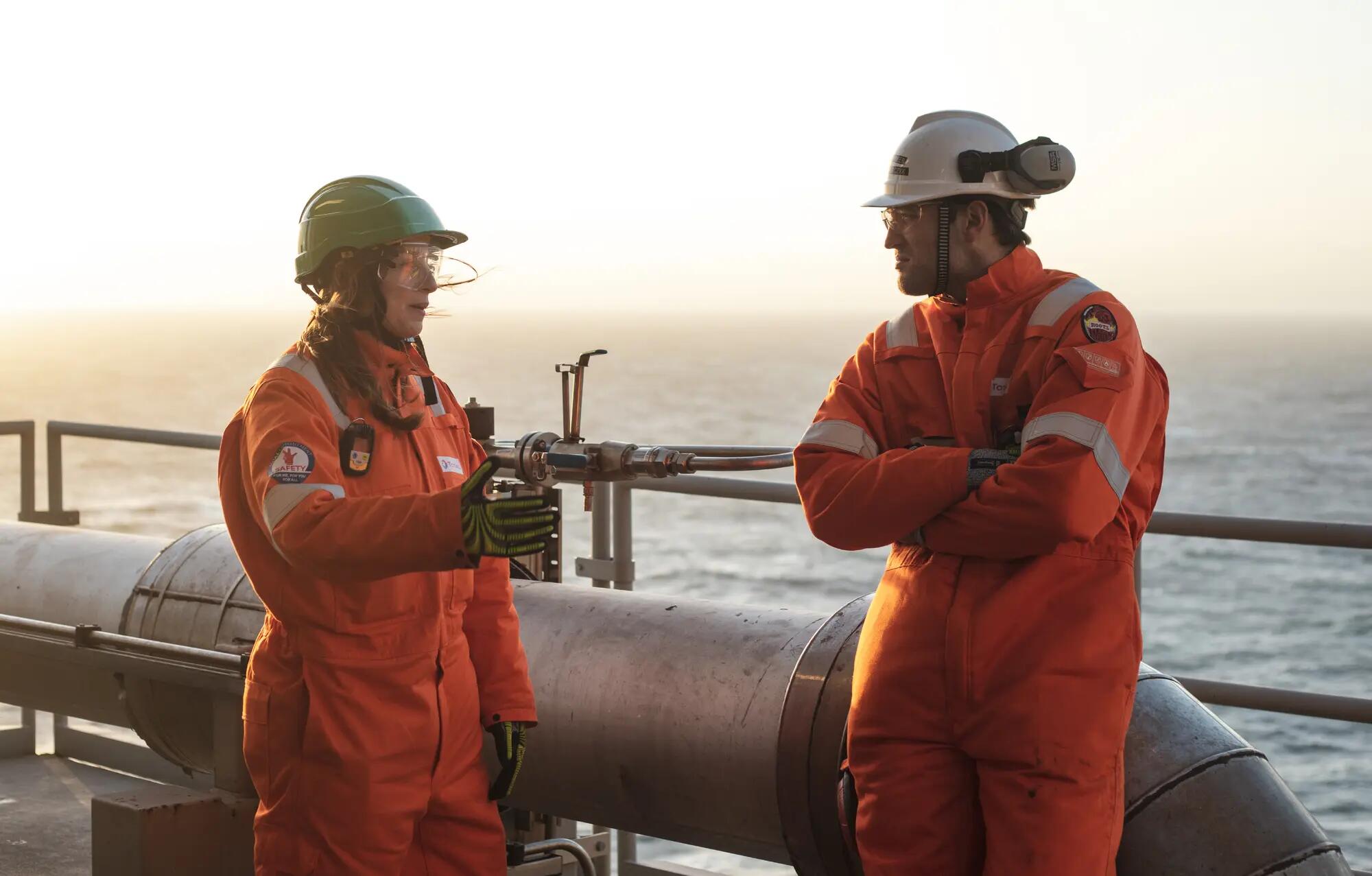 Two people talking on an offshore platform 