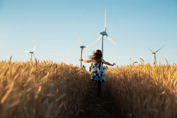 An image of a girl running through wheat fields.