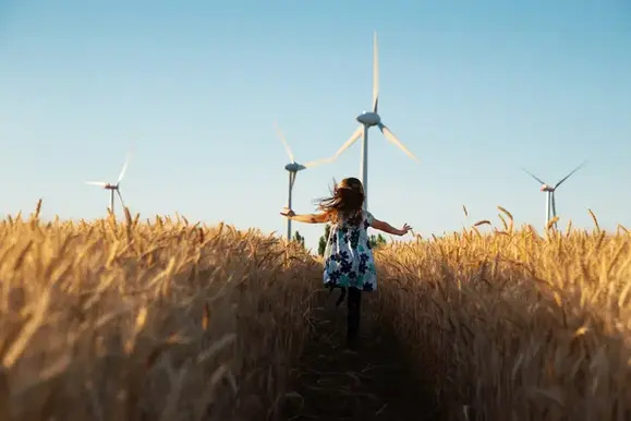 An image of a girl running through wheat fields.