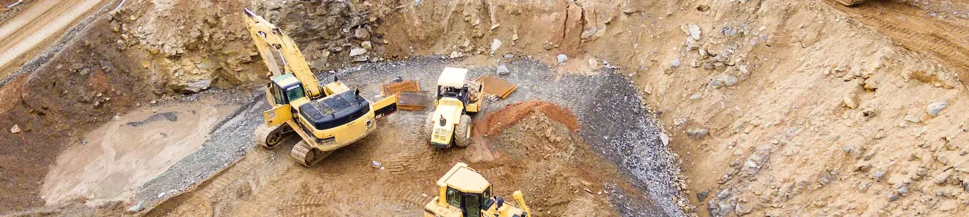 3 heavy equipment at mining site