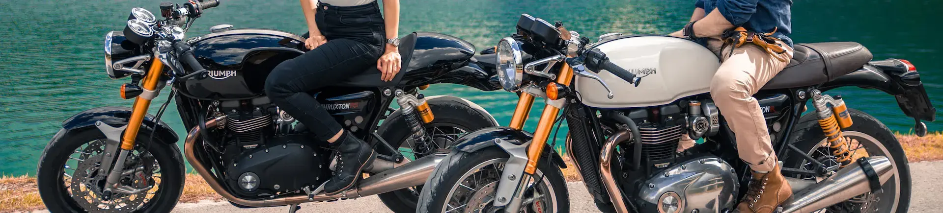 2 motorcycles parked along a lake