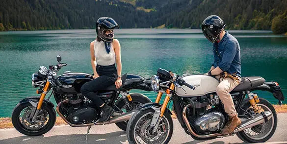 2 motorcycles parked along a lake