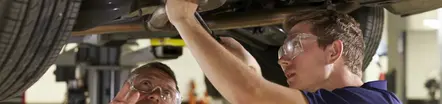 2 mechanics fixing a car