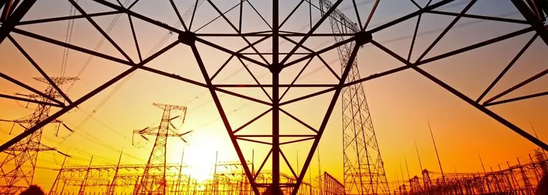 Image of a sunset through electricity line