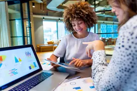 An image of two people discussing a business quote in an office.