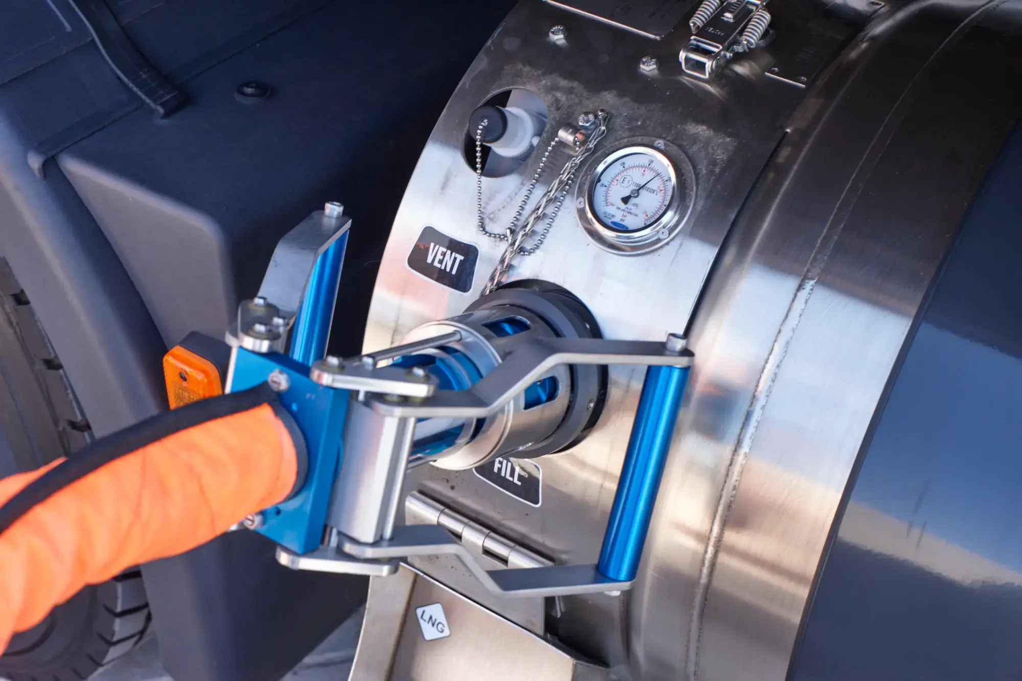 A refueling nozzle attached to a truck, illustrating the process of refueling the truck with LNG