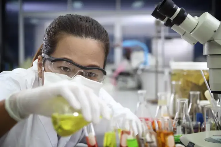 Chemist pouring flask