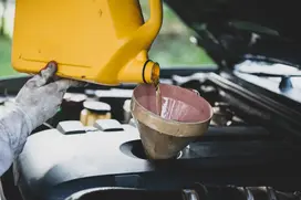 pouring engine oil into car
