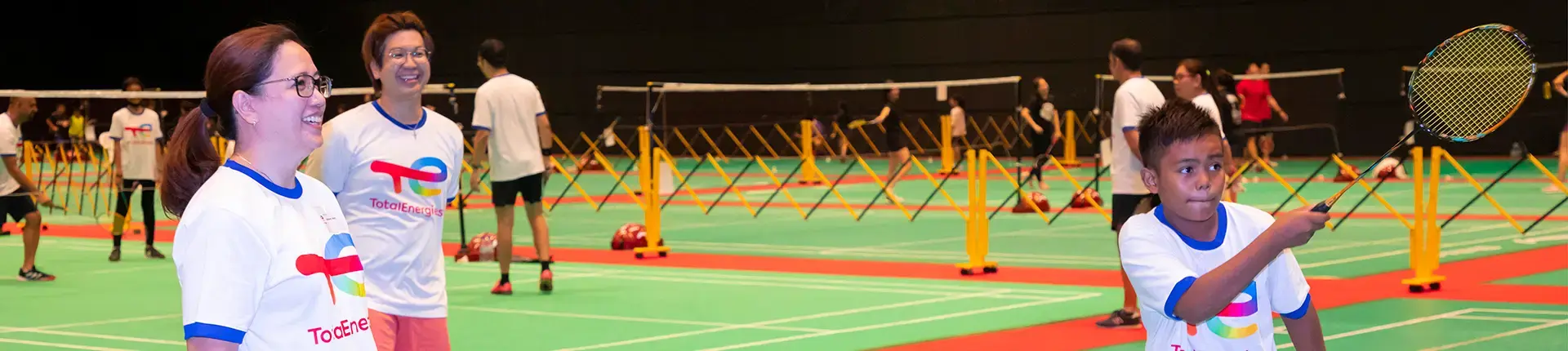 youth playing badminton with TotalEnergies employees