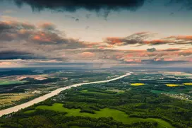 An image of the green countryside and sunset.