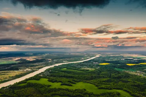 An image of the green countryside and sunset.