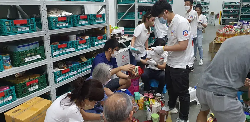 employees sorting out food at FoodBank warehouse