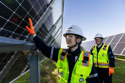 Female engineer touching panel at a solar site in Texas.